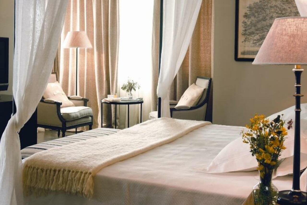เอเชีย การ์เดน โฮเต็ล แอนด์ ไทย สปา อะ รอยัล ไฮดะเวย์ โฮเต็ล Hotel ฟีเนสตรัต ภายนอก รูปภาพ A bedroom at the Mandarin Oriental, Bangkok